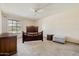 Spacious bedroom with a ceiling fan and a large window providing natural light at 10468 W Palmeras Dr, Sun City, AZ 85373