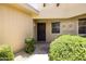 Inviting front entry featuring decorative shrubs and a secure, dark-stained front door at 10468 W Palmeras Dr, Sun City, AZ 85373
