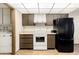 Kitchen featuring wood-grain cabinets, an electric range, and a black refrigerator at 10468 W Palmeras Dr, Sun City, AZ 85373