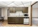 Well-lit kitchen featuring wood-grain cabinets, updated countertops, and essential appliances at 10468 W Palmeras Dr, Sun City, AZ 85373