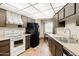 Well-lit kitchen featuring wood cabinets, updated appliances, and a view of the dining area at 10468 W Palmeras Dr, Sun City, AZ 85373