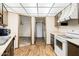 Kitchen featuring wood-look flooring, and opening to living room and laundry area at 10468 W Palmeras Dr, Sun City, AZ 85373