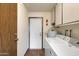 Functional laundry area with a washer and dryer, cabinets, and access to the exterior at 10468 W Palmeras Dr, Sun City, AZ 85373