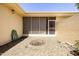Private patio features decorative gravel and a cute screened-in porch with entry door at 10468 W Palmeras Dr, Sun City, AZ 85373