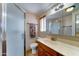 Bathroom with a framed sliding glass door, window, and vanity with a mirror and counter top at 111 S Greenfield Rd # 547, Mesa, AZ 85206
