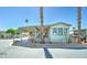 Cozy manufactured home boasts a covered carport and attractive landscaping, enhancing its curb appeal in a friendly neighborhood at 111 S Greenfield Rd # 547, Mesa, AZ 85206