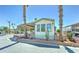 Delightful manufactured home enhanced by mature palm trees and thoughtful landscaping, offering a welcoming curb appeal at 111 S Greenfield Rd # 547, Mesa, AZ 85206