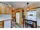 Spacious kitchen with natural wood cabinets, modern appliances, and a convenient breakfast bar for casual dining at 111 S Greenfield Rd # 547, Mesa, AZ 85206