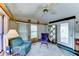 Bright, carpeted living room featuring a ceiling fan, cozy seating, and abundant natural light at 111 S Greenfield Rd # 547, Mesa, AZ 85206
