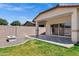 This home's spacious backyard includes a tiled patio, a stone fire pit, and a well-maintained lawn at 1272 W Joshua Tree Ave, Queen Creek, AZ 85140
