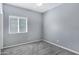 Neutral bedroom boasts a large window and plush carpeting for a cozy feel at 1272 W Joshua Tree Ave, Queen Creek, AZ 85140