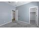 Neutral bedroom has plush carpets, ceiling fan, and includes closet and storage options at 1272 W Joshua Tree Ave, Queen Creek, AZ 85140