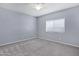 Bedroom with carpet, ceiling fan, window and neutral gray colored walls at 1272 W Joshua Tree Ave, Queen Creek, AZ 85140