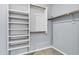 Well-organized walk-in closet featuring shelving and hanging rods to maximize storage at 1272 W Joshua Tree Ave, Queen Creek, AZ 85140