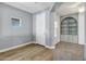 Welcoming entryway with wood floors and an open view into a cozy living room with built-in shelving at 1272 W Joshua Tree Ave, Queen Creek, AZ 85140