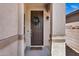 Inviting entryway featuring a craftsman-style door with decorative wreath and textured stucco columns at 1272 W Joshua Tree Ave, Queen Creek, AZ 85140