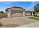 Charming single-story home with a well-manicured lawn and a paver driveway at 1272 W Joshua Tree Ave, Queen Creek, AZ 85140