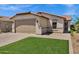 Charming single-story home with a well-manicured lawn and a paver driveway at 1272 W Joshua Tree Ave, Queen Creek, AZ 85140