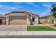 Charming single-story home with a well-manicured lawn and a tan color scheme at 1272 W Joshua Tree Ave, Queen Creek, AZ 85140
