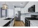 Kitchen with dark sink and stainless steel appliances, and white cabinets at 1272 W Joshua Tree Ave, Queen Creek, AZ 85140