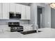 Close up of the kitchen features stainless steel appliances, and quartz counters at 1272 W Joshua Tree Ave, Queen Creek, AZ 85140