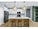 Bright kitchen featuring a large island with seating, quartz counters, and stainless steel appliances at 1272 W Joshua Tree Ave, Queen Creek, AZ 85140