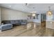 Open-concept living room showcases wood floors, modern lighting, and seamless flow into the kitchen at 1272 W Joshua Tree Ave, Queen Creek, AZ 85140