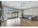 Living room with recessed lights, a ceiling fan, and sliding glass doors to the backyard at 1272 W Joshua Tree Ave, Queen Creek, AZ 85140