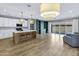 Bright open-concept living space with a spacious island, modern lighting, and access to the outdoor patio at 1272 W Joshua Tree Ave, Queen Creek, AZ 85140
