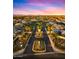 Community entrance with lush landscaping, palm trees and decorative stonework, aerial view at 13820 W Weaver Ct, Litchfield Park, AZ 85340