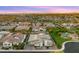 Expansive aerial view of a residential neighborhood highlighting a home with lush backyard, grass, and community landscape at 13820 W Weaver Ct, Litchfield Park, AZ 85340