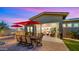 Tranquil backyard with outdoor dining and lounge areas, perfect for enjoying evenings outside at 13820 W Weaver Ct, Litchfield Park, AZ 85340