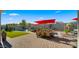 Beautiful backyard featuring a pool, lush landscaping, and outdoor dining, perfect for summer gatherings at 13820 W Weaver Ct, Litchfield Park, AZ 85340