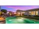 Lush backyard showcasing a sparkling pool, grassy lawn, and an outdoor dining area perfect for entertaining guests at 13820 W Weaver Ct, Litchfield Park, AZ 85340