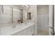 Bathroom with double vanity, mirrors, and decorative flowers at 13820 W Weaver Ct, Litchfield Park, AZ 85340
