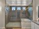 Luxurious bathroom with a glass-enclosed shower, soaking tub, and views to the garden at 13820 W Weaver Ct, Litchfield Park, AZ 85340