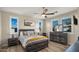 Bright bedroom with wood floors, ceiling fan, and stylish decor, creating a comfortable retreat at 13820 W Weaver Ct, Litchfield Park, AZ 85340