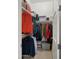 Walk-in closet with ample storage space and organized hanging clothes at 13820 W Weaver Ct, Litchfield Park, AZ 85340