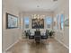 Elegant dining room with modern chandelier, large table, and windows providing natural light at 13820 W Weaver Ct, Litchfield Park, AZ 85340