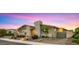 Attractive home exterior with stone accents, professional landscaping, and a welcoming entrance under a vibrant sunset at 13820 W Weaver Ct, Litchfield Park, AZ 85340