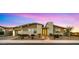 Charming single-story home featuring stone accents, manicured landscaping, and a welcoming illuminated entryway at 13820 W Weaver Ct, Litchfield Park, AZ 85340