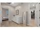 Spacious hallway with tile flooring, built-in cabinets, and access to the bedroom and closet at 13820 W Weaver Ct, Litchfield Park, AZ 85340