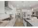 Well-equipped kitchen with white cabinetry, stainless steel appliances, and a view into the dining area at 13820 W Weaver Ct, Litchfield Park, AZ 85340