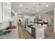 Stylish kitchen with white cabinets, stainless steel appliances, island with barstool seating, and open layout at 13820 W Weaver Ct, Litchfield Park, AZ 85340