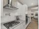 Close-up of a modern kitchen featuring stainless steel appliances, white cabinets, and a stylish backsplash at 13820 W Weaver Ct, Litchfield Park, AZ 85340