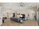 Spacious living room with tile floors, high ceilings, sleek furniture, and seamless indoor-outdoor living at 13820 W Weaver Ct, Litchfield Park, AZ 85340