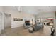 Bright living room with high ceilings, tile floors, modern furnishings, and views to the outdoor patio at 13820 W Weaver Ct, Litchfield Park, AZ 85340