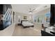 Spacious main bedroom with large windows, ceiling fan, and tile flooring offering a bright and airy feel at 13820 W Weaver Ct, Litchfield Park, AZ 85340