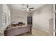 Well-lit office with tile floors, ceiling fan, built-in cabinets, and a comfortable workspace at 13820 W Weaver Ct, Litchfield Park, AZ 85340