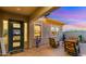 Inviting covered patio featuring stylish chairs and desert landscaping, perfect for relaxing evenings outdoors at 13820 W Weaver Ct, Litchfield Park, AZ 85340